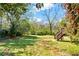 Large backyard with grass and trees, featuring a staircase to a raised deck at 955 Bouldercrest Se Dr, Atlanta, GA 30316
