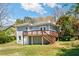 Exterior of house with a deck, grassy yard, and mature trees at 955 Bouldercrest Se Dr, Atlanta, GA 30316