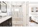 Bathroom with a tile shower, a glass door, a double vanity and hardwood floors leads to the bedroom at 955 Bouldercrest Se Dr, Atlanta, GA 30316