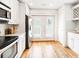Well-lit kitchen with stainless steel appliances, hardwood floors, and white cabinets offers backyard access at 955 Bouldercrest Se Dr, Atlanta, GA 30316