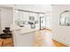 Modern white kitchen featuring stainless steel appliances and a breakfast bar at 955 Bouldercrest Se Dr, Atlanta, GA 30316