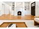 Open-concept living room featuring a fireplace, built-in shelving, and hardwood floors at 955 Bouldercrest Se Dr, Atlanta, GA 30316