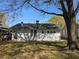 The back exterior of the home has a mature shade tree and chain link fence at 1012 Burns Dr, Atlanta, GA 30310