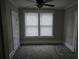 Neutral bedroom with painted walls, carpet flooring, a ceiling fan and natural light from multiple windows at 1012 Burns Dr, Atlanta, GA 30310