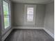 Neutral bedroom with painted walls, carpet flooring, base trim, and natural light from multiple windows at 1012 Burns Dr, Atlanta, GA 30310
