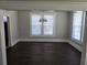Dining area enhanced by bright windows, dark floors and chandelier, creating a welcoming ambiance at 1012 Burns Dr, Atlanta, GA 30310