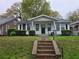 Charming single story home with a concrete staircase leading to a covered front porch entrance at 1012 Burns Dr, Atlanta, GA 30310