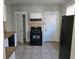 Kitchen featuring granite countertops, tiled flooring, and black appliances, offering functionality and style at 1012 Burns Dr, Atlanta, GA 30310