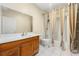 Full bathroom with single vanity, storage and shower with neutral color shower curtain at 1395 Brisbane Dr, Dacula, GA 30019