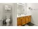 This is a full bathroom featuring double sinks, a toilet and vanity storage space at 1395 Brisbane Dr, Dacula, GA 30019