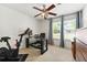 Bedroom with an exercise bike, desk, chair and windows with curtains at 1395 Brisbane Dr, Dacula, GA 30019