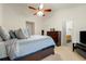 Bedroom with neutral carpet featuring a bed with plenty of pillows and an adjacent bathroom with a view into bedroom at 1395 Brisbane Dr, Dacula, GA 30019