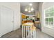 Bright breakfast nook with a small table, chair, and views into the kitchen at 1395 Brisbane Dr, Dacula, GA 30019