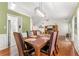 Bright dining room with hardwood floors, contemporary lighting, and a dining table set for six at 1395 Brisbane Dr, Dacula, GA 30019