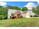 Side view of a well-maintained home featuring brick and siding, a neat lawn, and an attached garage at 1395 Brisbane Dr, Dacula, GA 30019