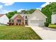 Charming single-Gathering home with brick and siding exterior, manicured lawn, and attached garage at 1395 Brisbane Dr, Dacula, GA 30019