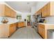 Well-lit kitchen with light wood cabinets, stainless steel appliances, and tile flooring at 1395 Brisbane Dr, Dacula, GA 30019