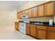 Kitchen with tile floors featuring an oven, microwave, cabinets and a stainless steel sink at 1395 Brisbane Dr, Dacula, GA 30019