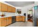 Kitchen with stainless steel appliances, light wood cabinets, and tile flooring at 1395 Brisbane Dr, Dacula, GA 30019
