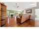 Spacious living room with hardwood floors, fireplace, ceiling fan, and ample natural light at 1395 Brisbane Dr, Dacula, GA 30019