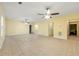 The living room features tile floors, ceiling fans, neutral paint and views into adjacent rooms at 1395 Brisbane Dr, Dacula, GA 30019
