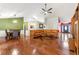 Spacious open-concept living room with hardwood floors seamlessly connecting to the dining area and entryway at 1395 Brisbane Dr, Dacula, GA 30019