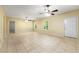 This living room features tiled floors, ceiling fans, natural light and a view into an adjacent room at 1395 Brisbane Dr, Dacula, GA 30019
