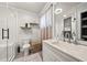 Bathroom featuring walk-in shower, modern vanity, framed mirror, and floating shelves at 1755 Fairburn Sw Rd, Atlanta, GA 30331