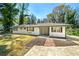 Inviting home with a well-manicured lawn, brick walkway, and mature trees at 1755 Fairburn Sw Rd, Atlanta, GA 30331