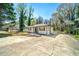 Charming home with a well-maintained lawn, mature trees, and ample parking space at 1755 Fairburn Sw Rd, Atlanta, GA 30331