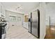 Charming kitchen with granite counters, white cabinets, stainless steel fridge, and sunlit windows at 1755 Fairburn Sw Rd, Atlanta, GA 30331