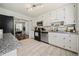 Bright kitchen with white cabinets, granite countertops, stainless steel appliances, and tile floors at 1755 Fairburn Sw Rd, Atlanta, GA 30331