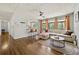 Comfortable living room featuring hardwood floors, large windows, open to bar seating and kitchen at 1755 Fairburn Sw Rd, Atlanta, GA 30331