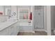 Stylish bathroom featuring dual sinks, modern fixtures, a tub, and separate shower at 5720 Crow Dr, Cumming, GA 30041