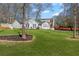 Charming home with well-manicured lawn, showcasing its inviting curb appeal and attached garage at 5720 Crow Dr, Cumming, GA 30041