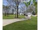 Well-maintained front yard with a lush lawn and winding driveway leading to an attached garage at 5720 Crow Dr, Cumming, GA 30041