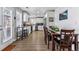 Bright open kitchen and dining area with white cabinets, stainless appliances, and wood floors at 5720 Crow Dr, Cumming, GA 30041