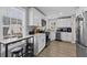 Modern kitchen featuring white cabinets, stainless steel appliances, and a cozy breakfast bar at 5720 Crow Dr, Cumming, GA 30041