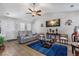 Bright living room featuring vaulted ceilings, wood-look floors, and a plush blue rug at 5720 Crow Dr, Cumming, GA 30041