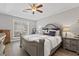 Comfortable main bedroom featuring tray ceiling, large window, and luxury decorative touches at 5720 Crow Dr, Cumming, GA 30041