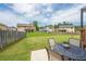 Backyard with a patio set for outdoor dining and a large grassy area at 8097 White Oak Loop, Lithonia, GA 30038