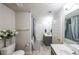 Bathroom with gray vanity, white accents, and shower tub with curtain at 8097 White Oak Loop, Lithonia, GA 30038