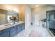 Bathroom features a double vanity with gray cabinets and tile flooring at 8097 White Oak Loop, Lithonia, GA 30038
