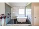 Bathroom featuring a modern soaking tub in glass-enclosed shower space at 8097 White Oak Loop, Lithonia, GA 30038