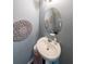 Stylish half bathroom with a pedestal sink and decorative mirror at 8097 White Oak Loop, Lithonia, GA 30038