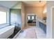 Primary bathroom with soaking tub, double vanity, and bedroom entrance at 8097 White Oak Loop, Lithonia, GA 30038