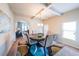 Elegant dining room with a round table, chandelier, and large windows for natural light at 8097 White Oak Loop, Lithonia, GA 30038