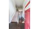 Inviting entryway with hardwood floors, staircase, and a bright red front door at 8097 White Oak Loop, Lithonia, GA 30038