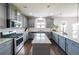 Well-lit gray kitchen featuring stainless steel appliances, center island, and granite countertops at 8097 White Oak Loop, Lithonia, GA 30038