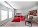 Comfortable living area with a red sectional sofa, desk, and a decorative tiger artwork at 8097 White Oak Loop, Lithonia, GA 30038